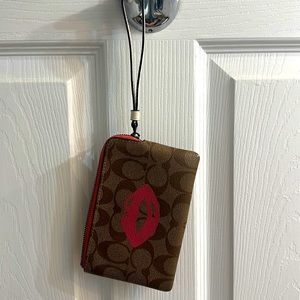 Coach logo with lip print wristlet wallet. Good condition.